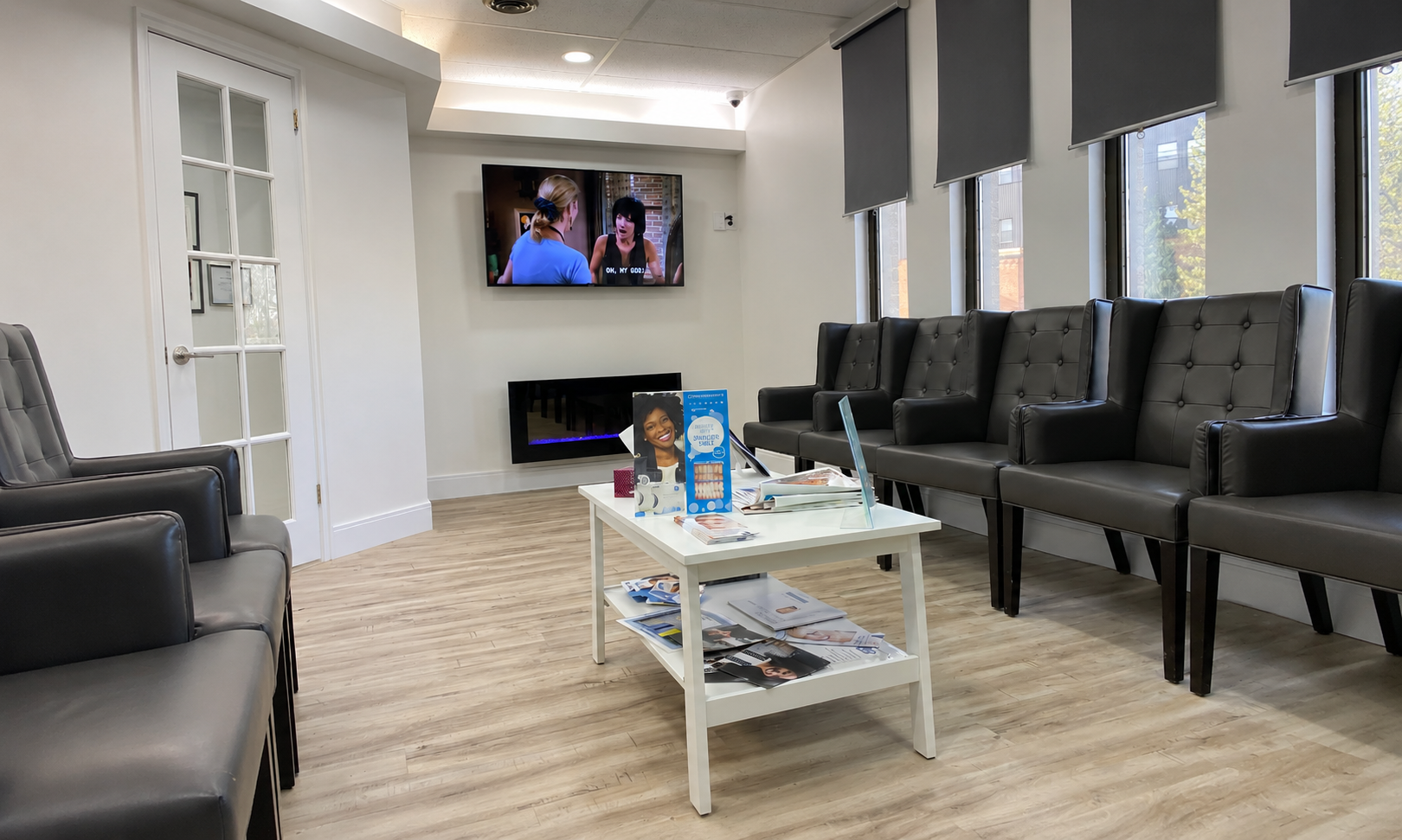 Welland Dental Centre waiting lounge with leather chairs, fireplace and TV