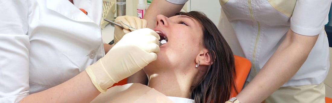 Restorative Dentistry in Welland, ON | Welland Dental Centre Dentist and assistant treating a young woman in the dental chair