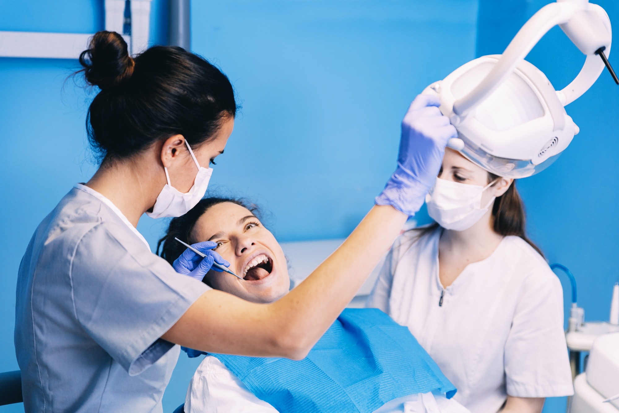 Dentist repairing a patient's chipped tooth in the treatment chair