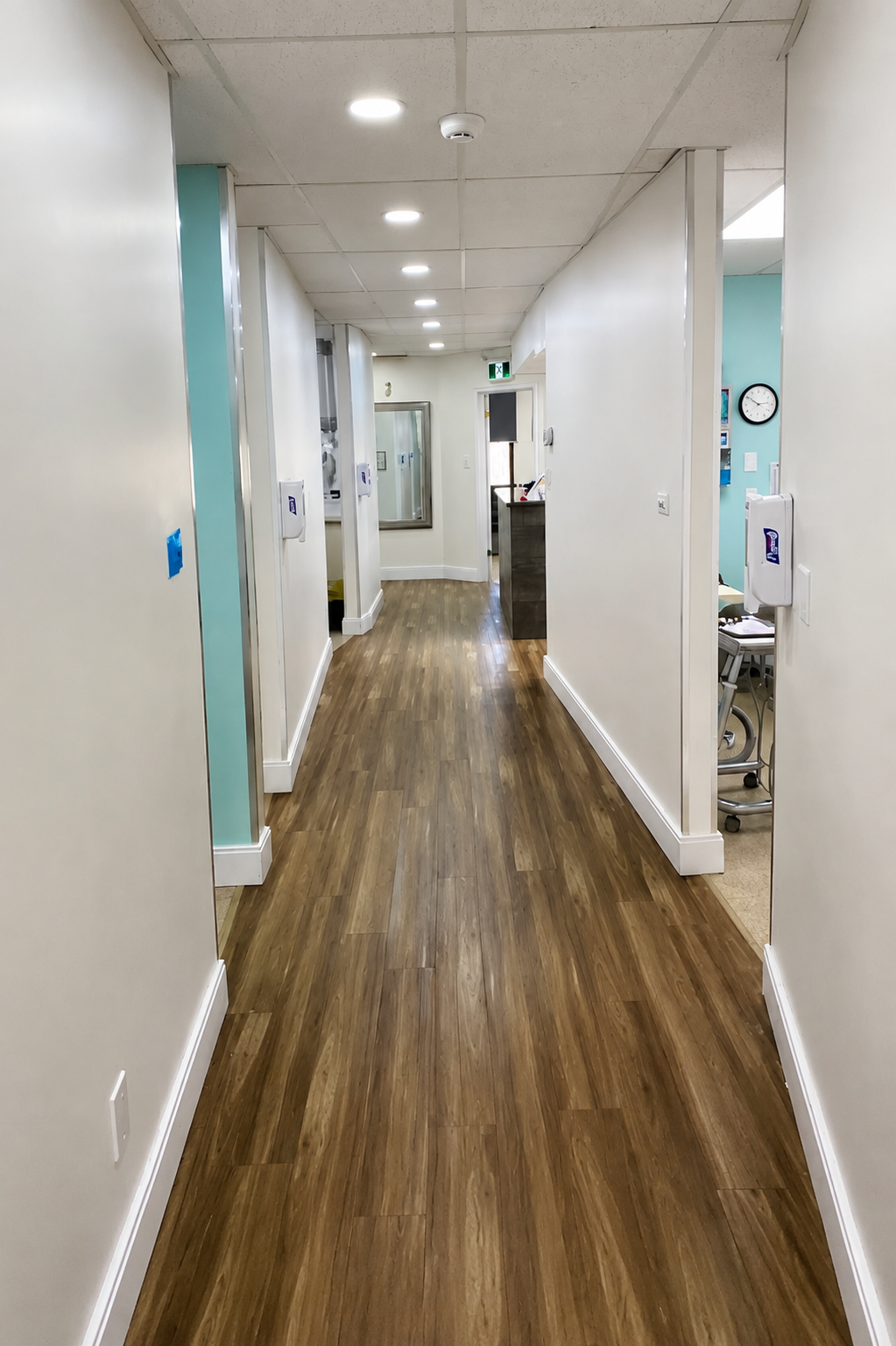 Bright clinic corridor leading to treatment rooms at Welland Dental Centre