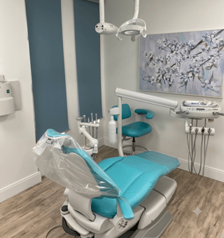 Teal dental chair in a calm private treatment room