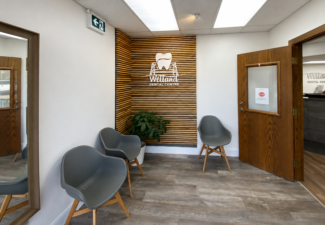 Welland Dental Centre waiting area with wooden slat logo wall and reception beyond