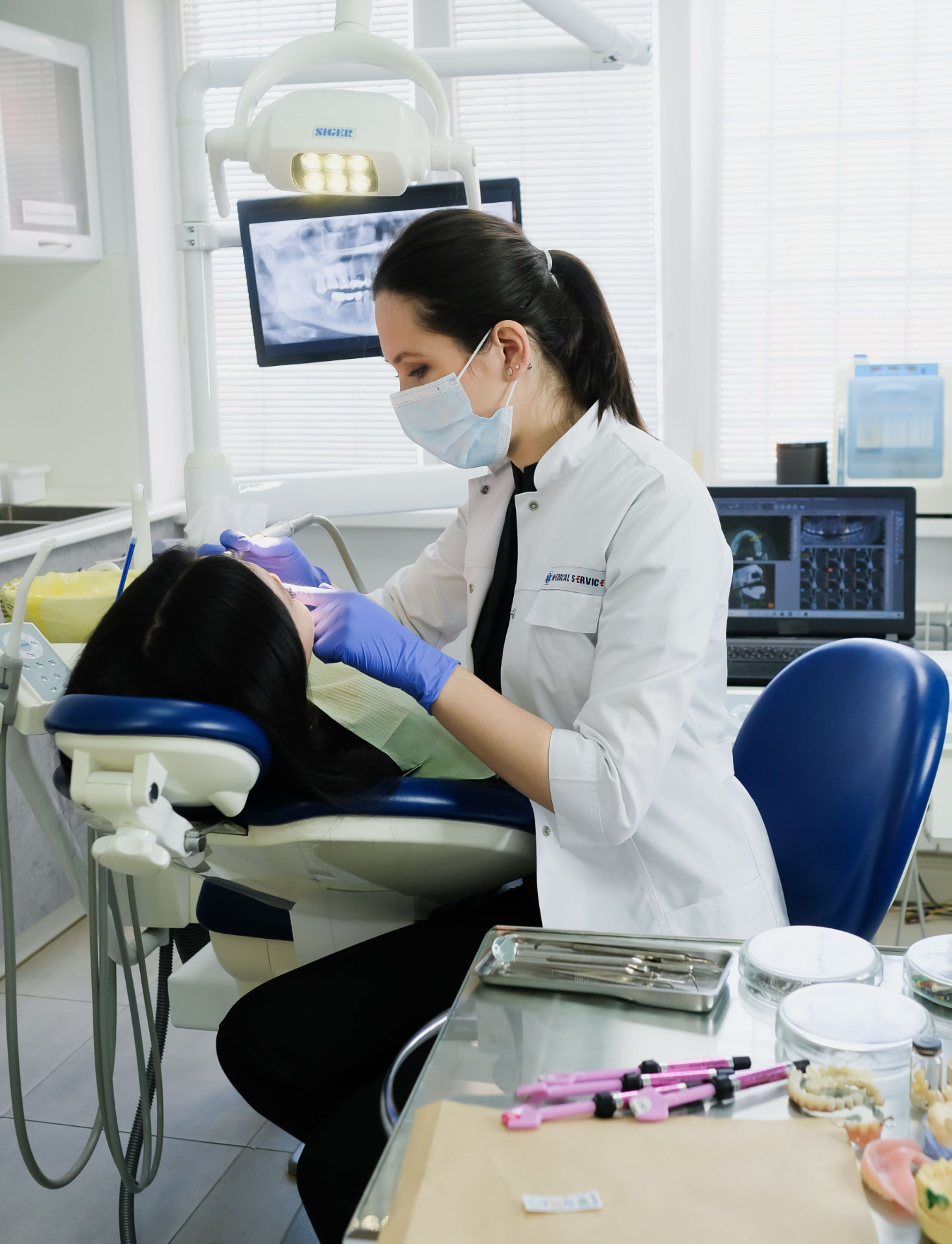 Dentist treating a patient in a modern Welland dental operatory