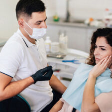 Dentist in Welland treating a patient with severe tooth ache.
